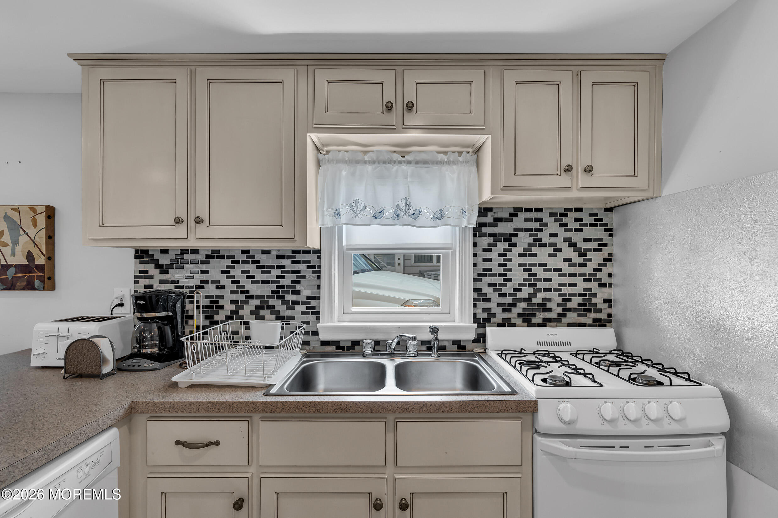21 East Bay Way Lavallette, NJ 08735 - Photo 5 of 23 a kitchen with a stove a sink and cabinets