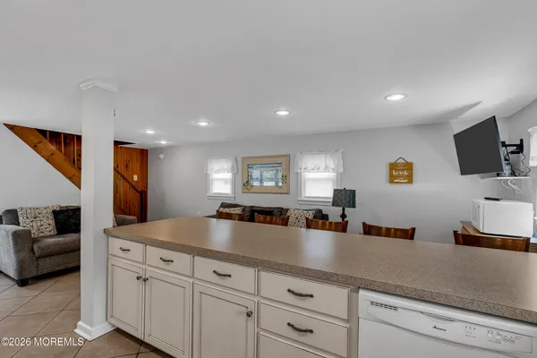 a kitchen with counter top space and living room