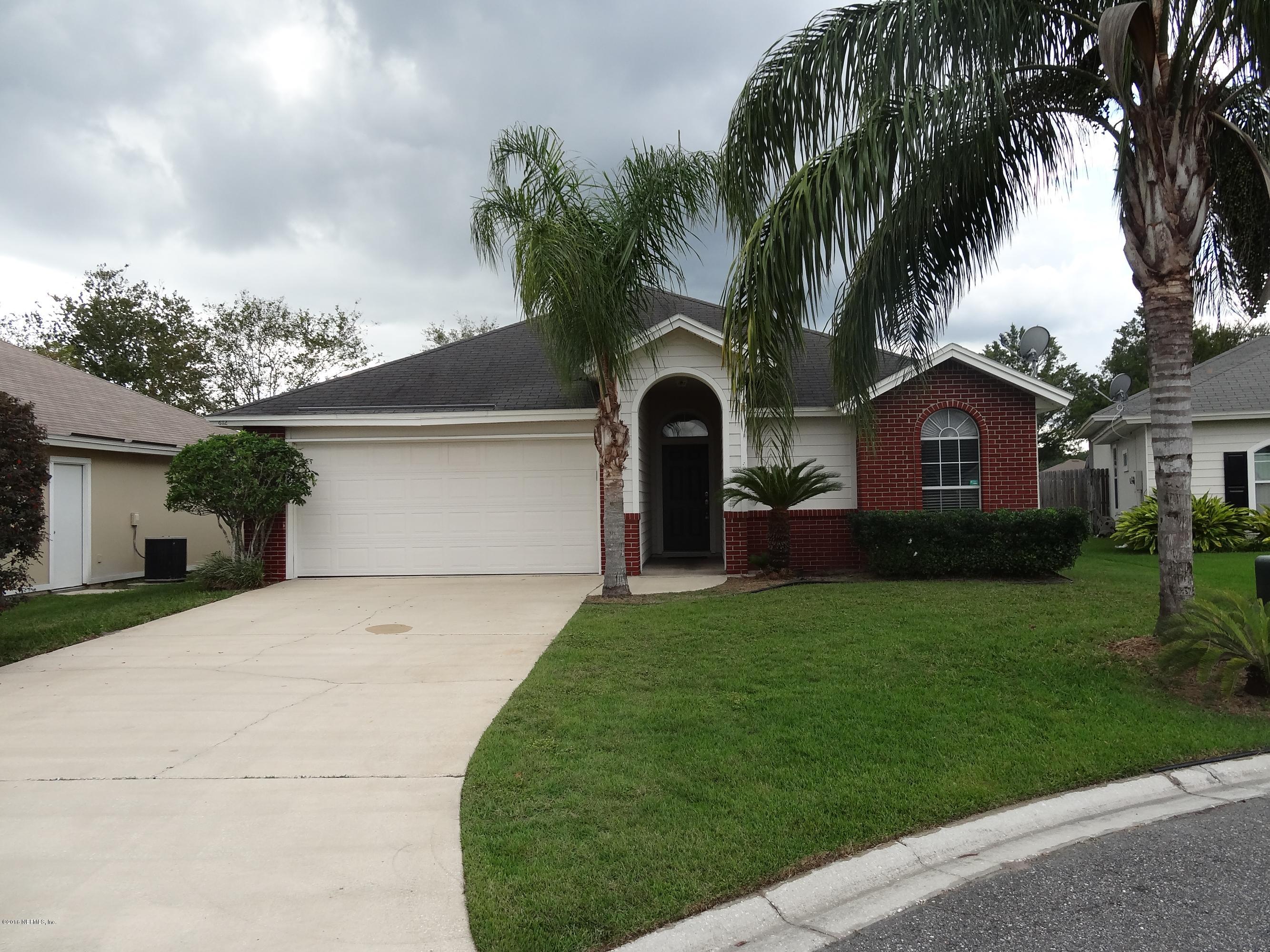 612 Morning Mist Way Orange Park, FL 32073 - Photo 1 of 12 a front view of a house with a garden