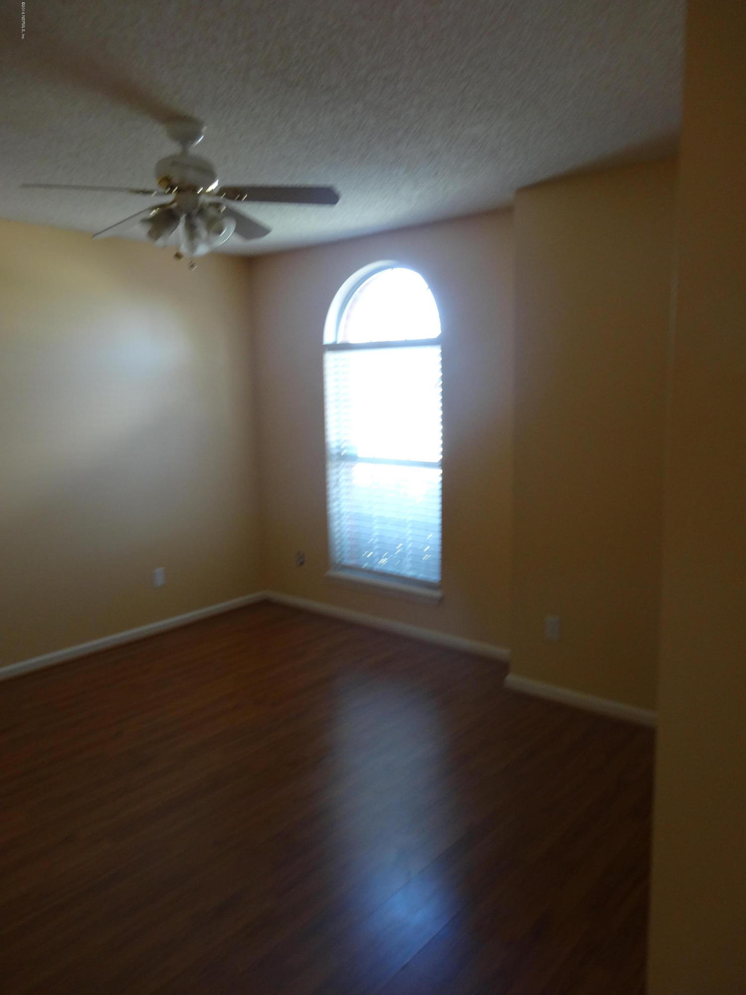 612 Morning Mist Way Orange Park, FL 32073 - Photo 11 of 12 an empty room with wooden floor and windows