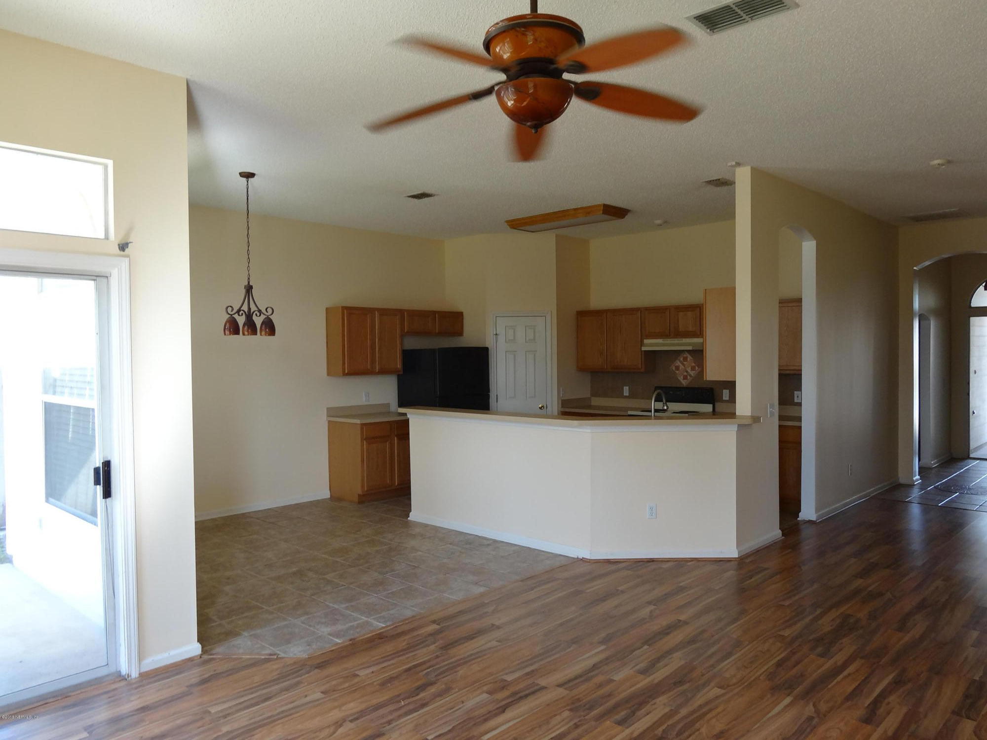 612 Morning Mist Way Orange Park, FL 32073 - Photo 3 of 12 a view of a kitchen with a sink and a refrigerator