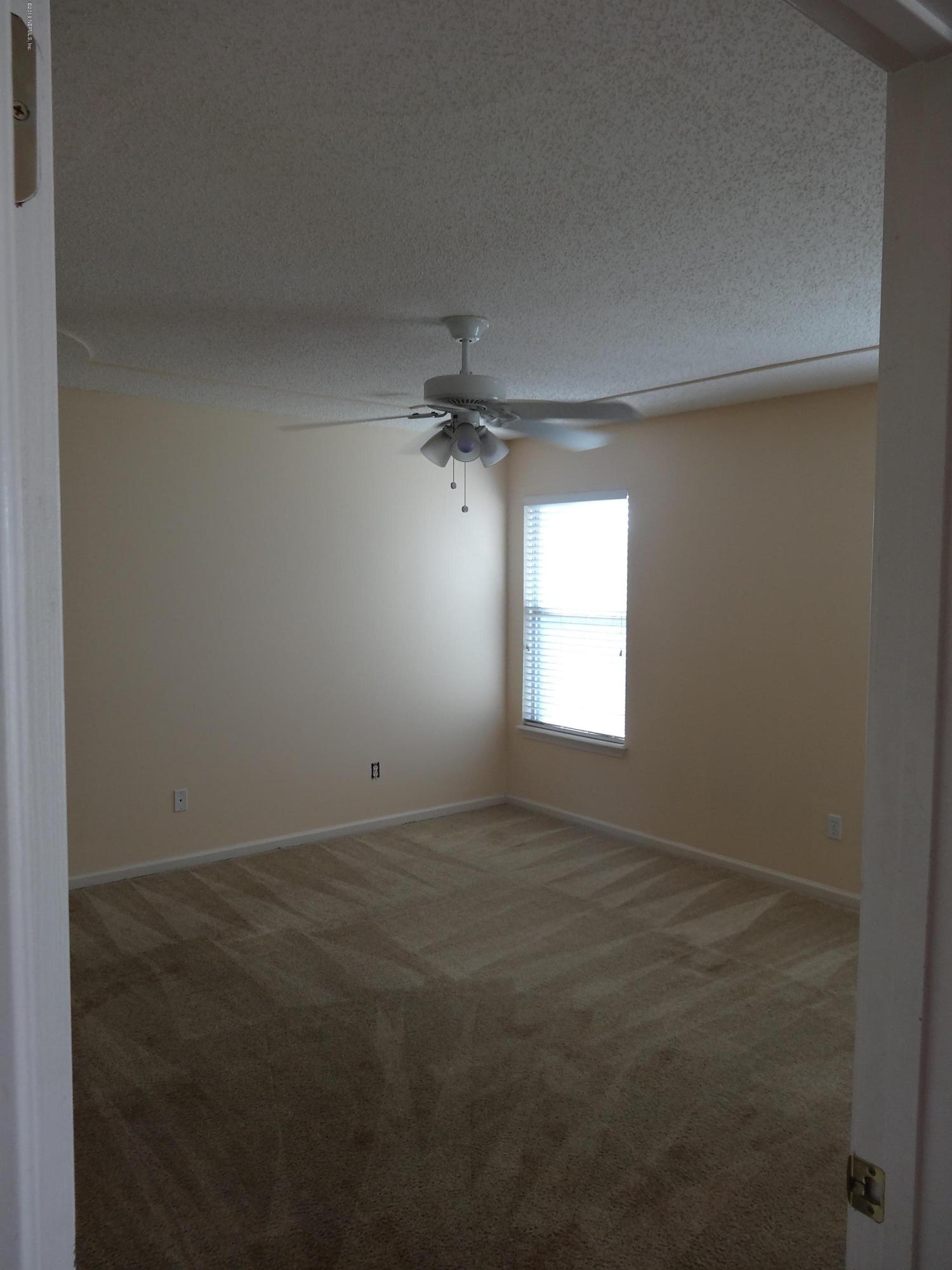612 Morning Mist Way Orange Park, FL 32073 - Photo 5 of 12 an empty room with a window