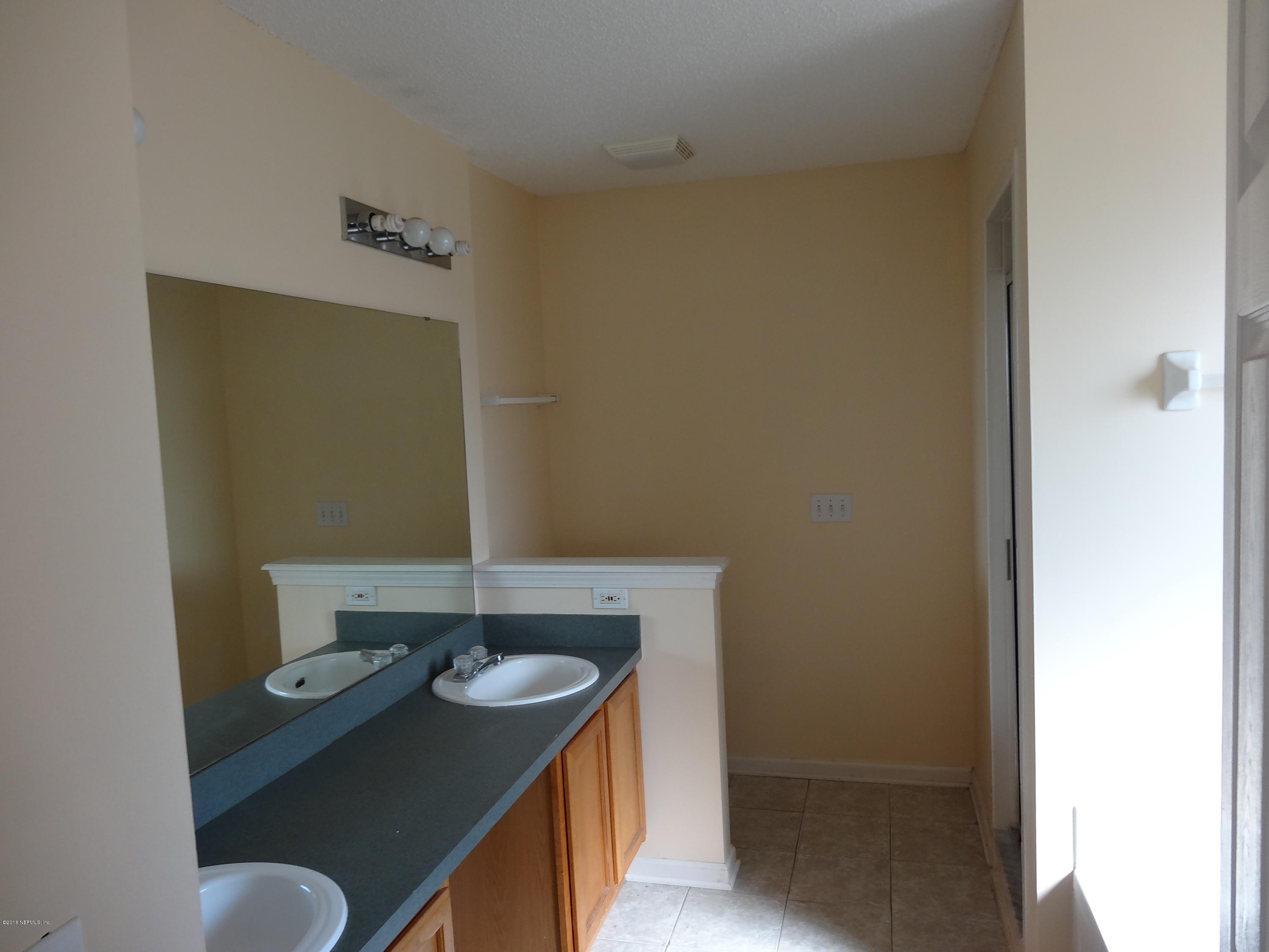 612 Morning Mist Way Orange Park, FL 32073 - Photo 6 of 12 a bathroom with a sink a toilet and a mirror