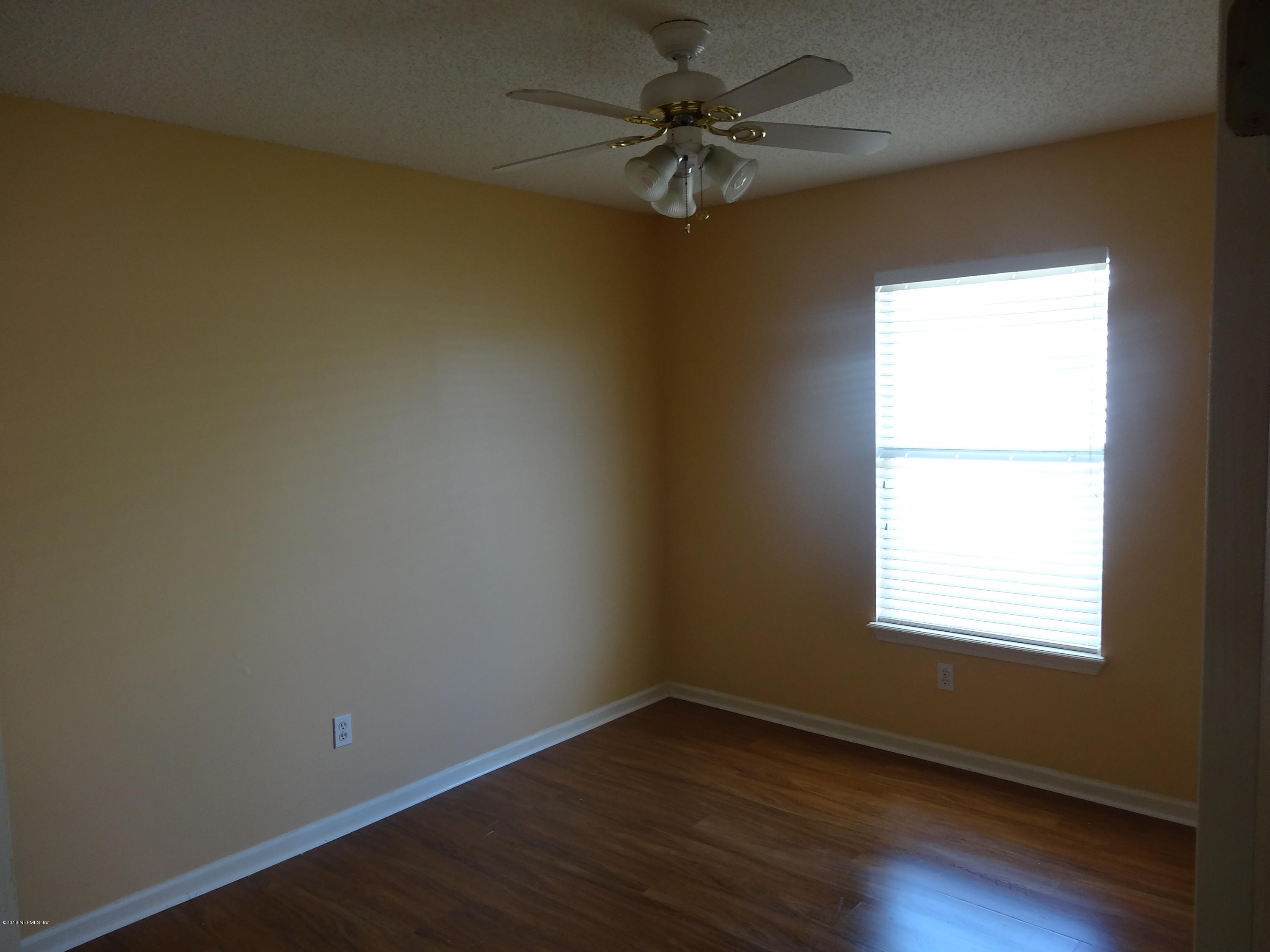 612 Morning Mist Way Orange Park, FL 32073 - Photo 10 of 12 an empty room with wooden floor and windows