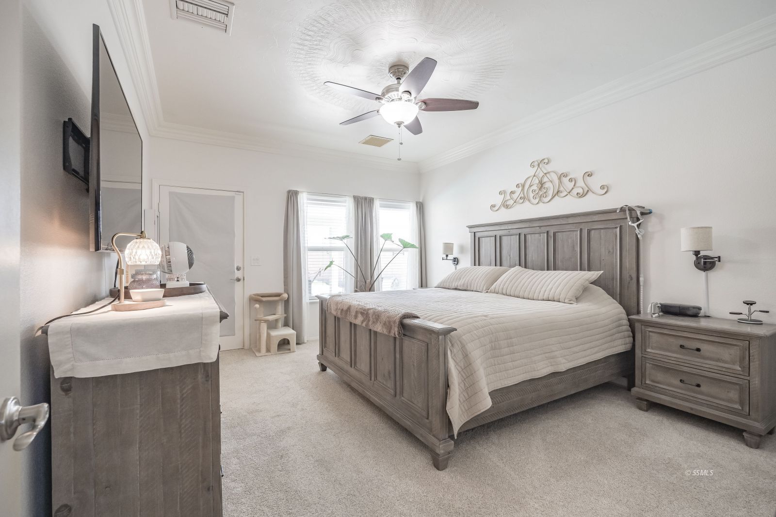 400 Acacia Street Ridgecrest, CA 93555 - Photo 26 of 45 a bedroom with a bed and a chandelier