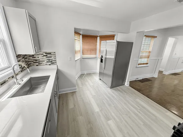a kitchen with wooden floors and appliances