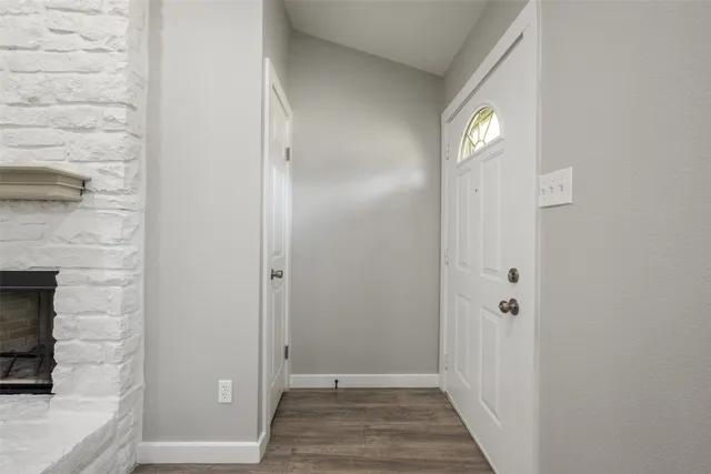 a large kitchen with stainless steel appliances a large counter top a stove and a refrigerator