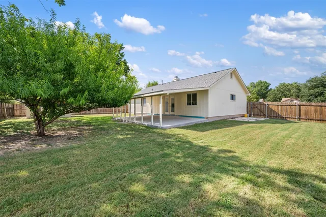 a view of house with backyard and garden