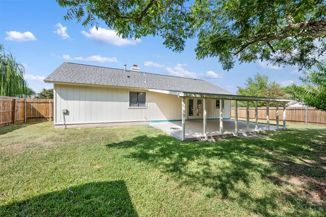 a view of a house with yard and a garden