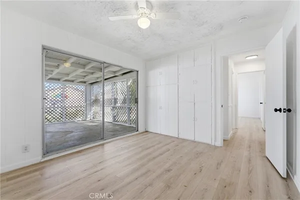 a view of a room with wooden floor and a large window