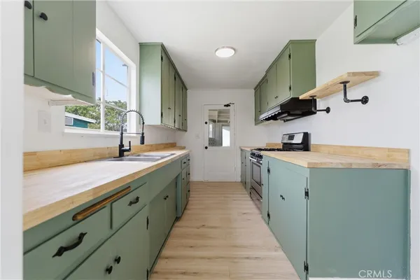 a kitchen with stainless steel appliances a sink and stove