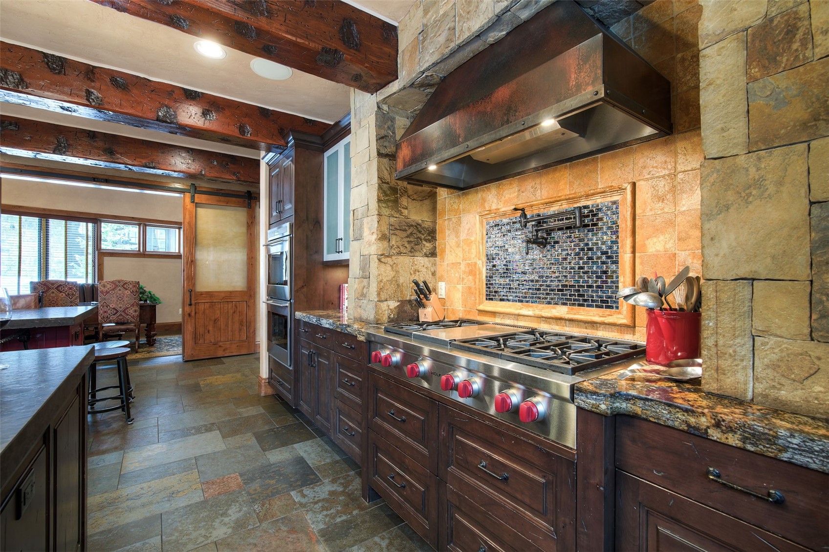 560 Beeler Place Frisco, CO 80443 - Photo 9 of 40 a kitchen with stainless steel appliances granite countertop a stove and a sink