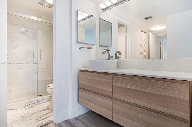 a bathroom with a shower and a mirror