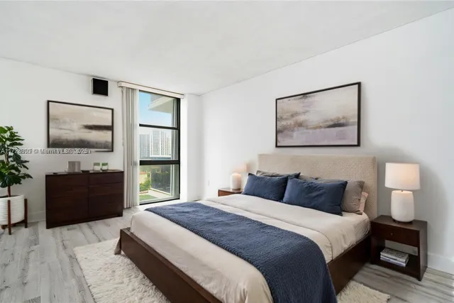 a bedroom with a bed and a flat screen tv