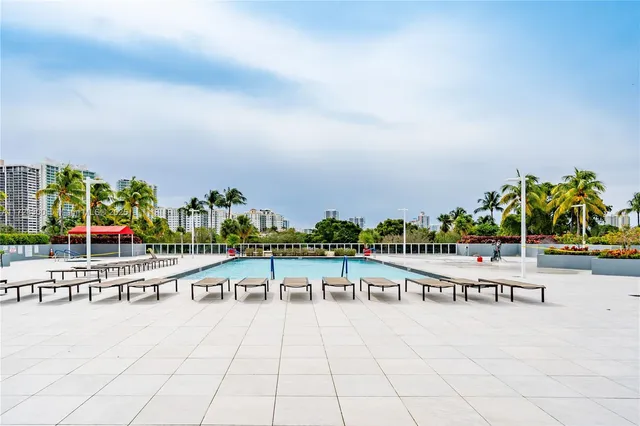 a view of swimming pool with outdoor seating and yard in the back