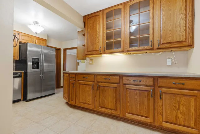 a kitchen with stainless steel appliances granite countertop a refrigerator and a sink