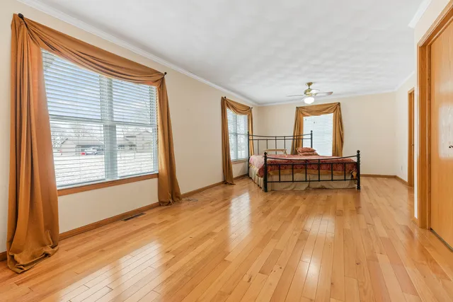 a bed sitting in a bedroom next to a window