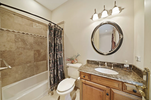 9600 Pacific Court Burr Ridge, IL 60527 - Photo 15 of 58 a bathroom with a granite countertop sink toilet mirror and shower