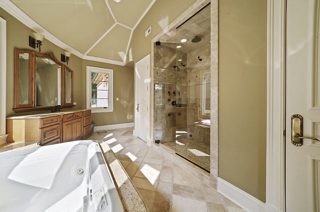 9600 Pacific Court Burr Ridge, IL 60527 - Photo 37 of 58 a spacious bathroom with a glass shower door and a bathtub