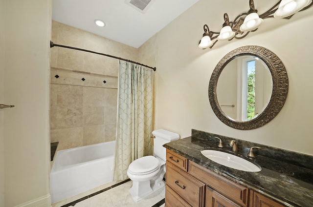 9600 Pacific Court Burr Ridge, IL 60527 - Photo 43 of 58 a bathroom with a granite countertop sink a toilet and a mirror