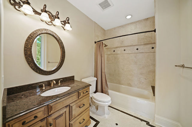 9600 Pacific Court Burr Ridge, IL 60527 - Photo 46 of 58 a bathroom with a granite countertop sink toilet mirror vanity and shower