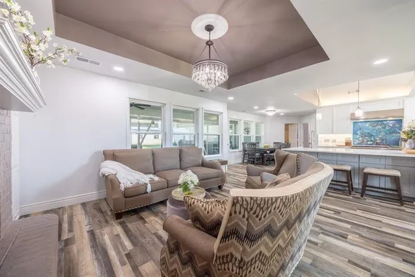 a living room with furniture fireplace and a large window