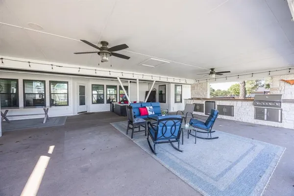 a view of a kitchen with stainless steel appliances granite countertop a sink and cabinets