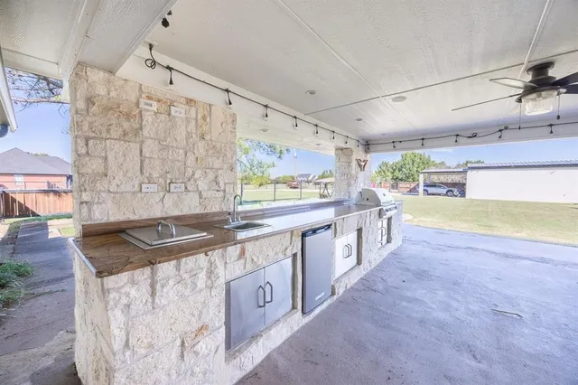 a kitchen with stainless steel appliances granite countertop a sink and dishwasher a stove top oven with wooden floor