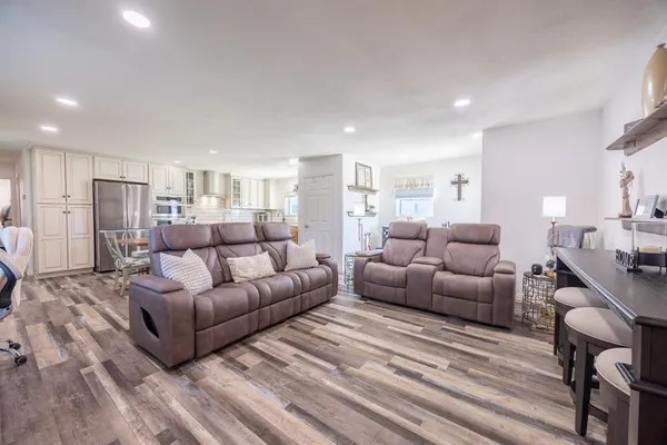 a kitchen with stainless steel appliances granite countertop a sink and dishwasher a stove top oven with wooden floor