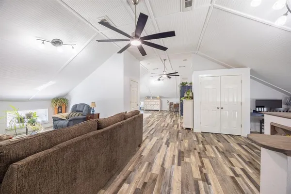 a living room with furniture and a wooden floor