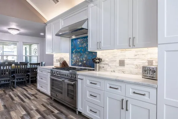 a kitchen with stainless steel appliances kitchen island granite countertop lots of counter top space and furniture