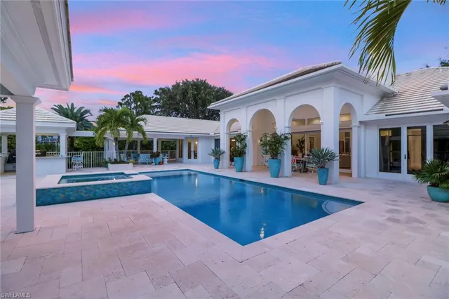 a view of a house with swimming pool and a porch