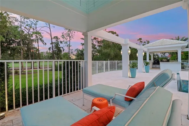 a view of a patio with couches table and chairs and potted plants