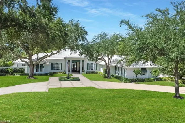 a front view of a house with a yard table and chairs