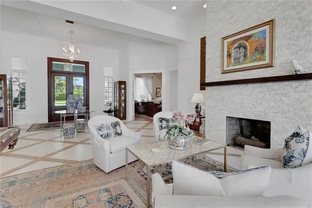 a living room with furniture a table and a fireplace