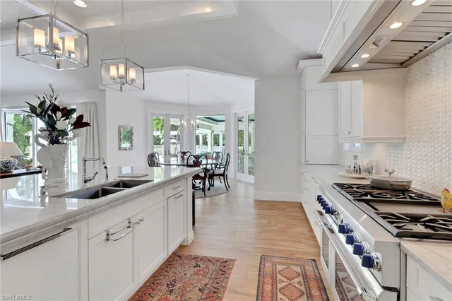 a kitchen with sink stove and cabinets