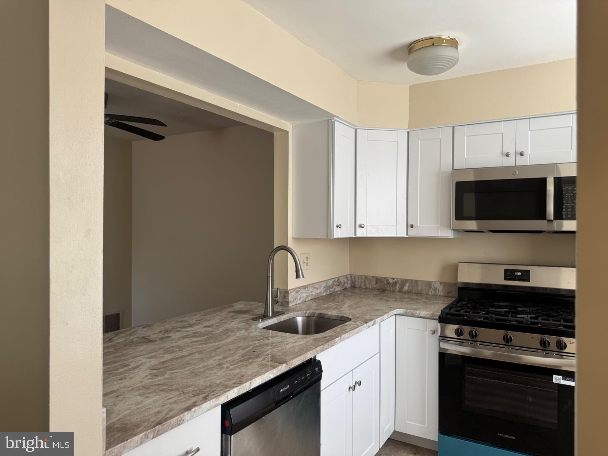 1908 B Ralston Drive Mount Laurel, NJ 08054 - Photo 4 of 21 a kitchen with stainless steel appliances granite countertop a sink and a stove