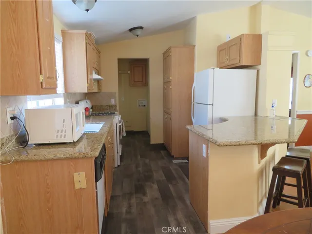 a living room with furniture a dining table and chairs