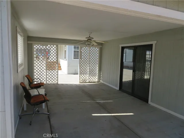 a view of room with window and a ceiling fan