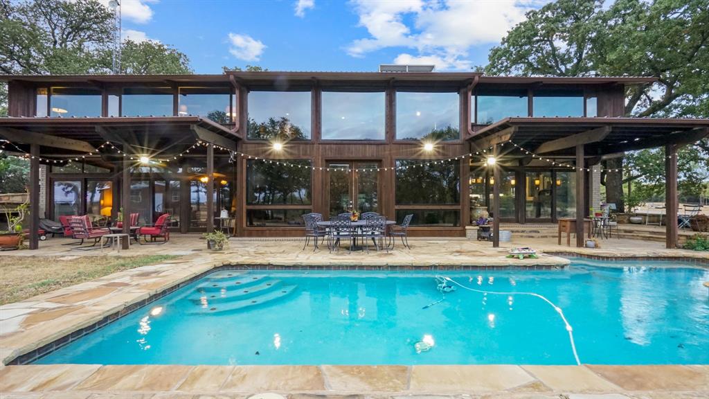 2710 Advance Road Poolville, TX 76487 - Photo 2 of 40 a view of a chairs with umbrellas on table and chairs