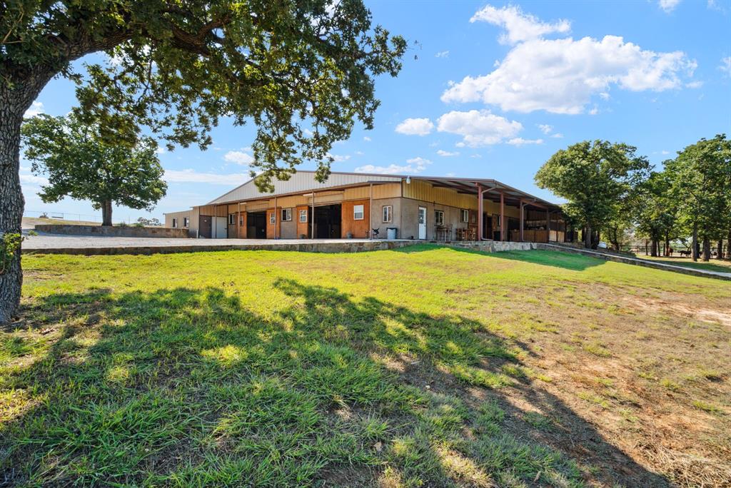 2710 Advance Road Poolville, TX 76487 - Photo 29 of 40 a view of a house with swimming pool and a yard