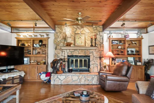 a living room with furniture a flat screen tv and a fireplace