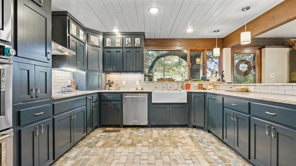 2710 Advance Road Poolville, TX 76487 - Photo 5 of 40 a kitchen with a sink cabinets and window