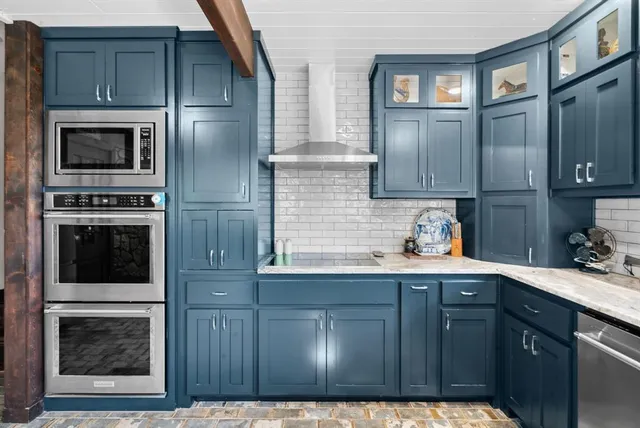 a kitchen with cabinets and stainless steel appliances