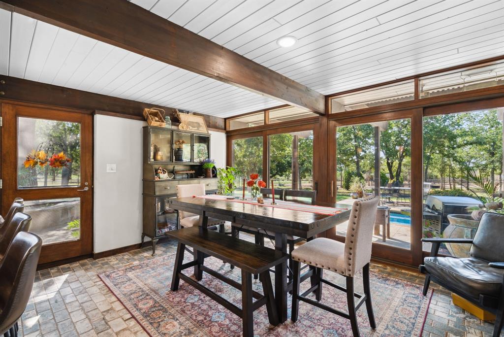 2710 Advance Road Poolville, TX 76487 - Photo 7 of 40 a view of a dining room with furniture large windows and wooden floor