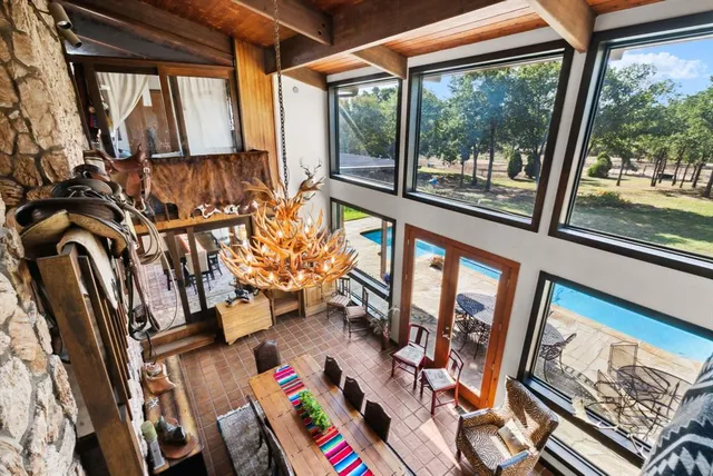 a living room with furniture and a floor to ceiling window