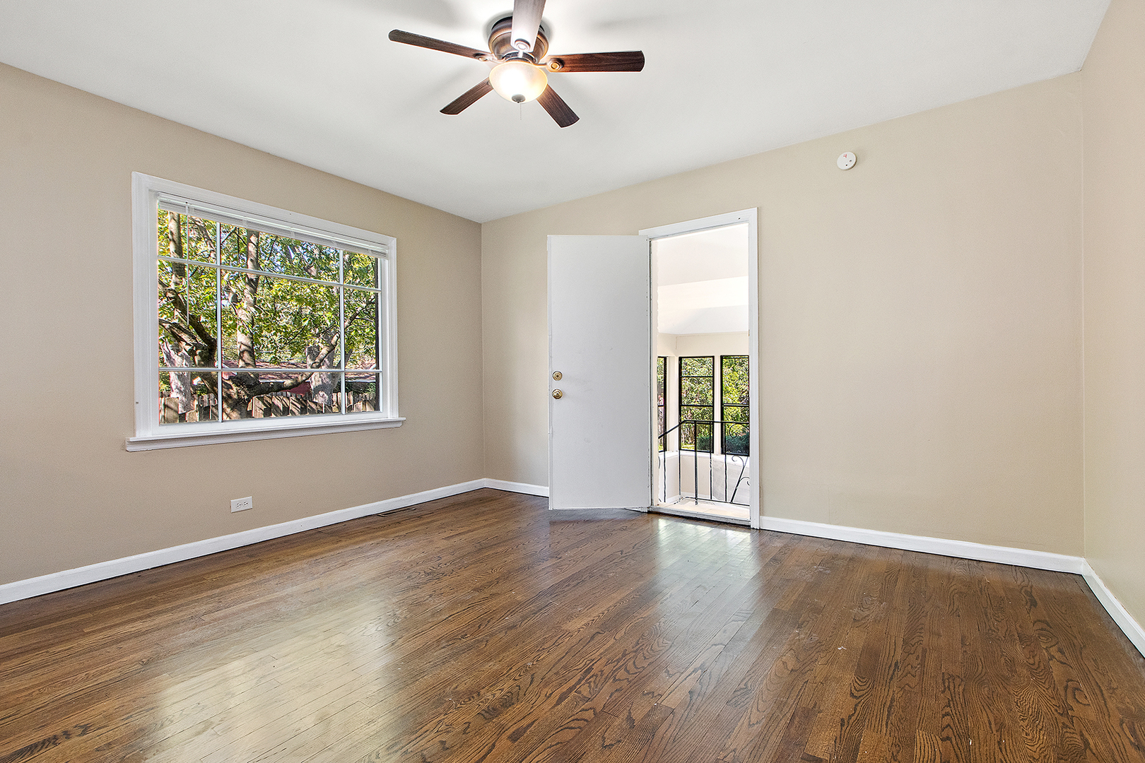 1718 West 187th Street Homewood, IL 60430 - Photo 7 of 28 a view of an empty room with wooden floor and a window