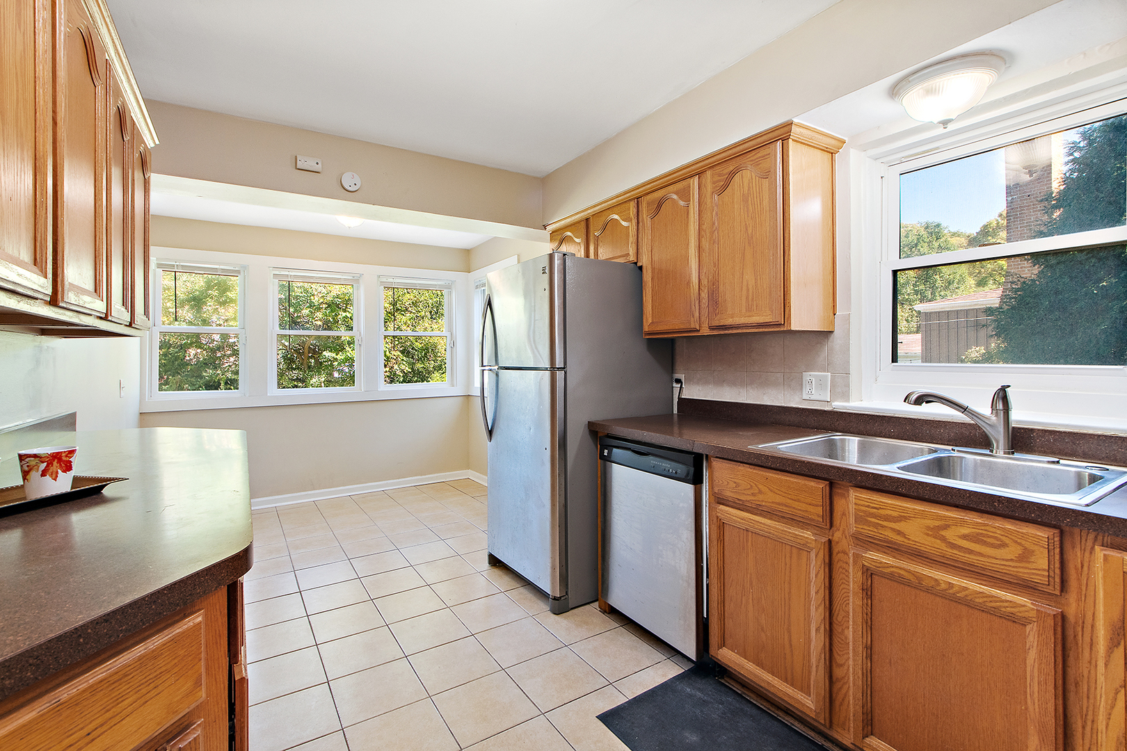 1718 West 187th Street Homewood, IL 60430 - Photo 8 of 28 a kitchen with stainless steel appliances a sink a refrigerator and window
