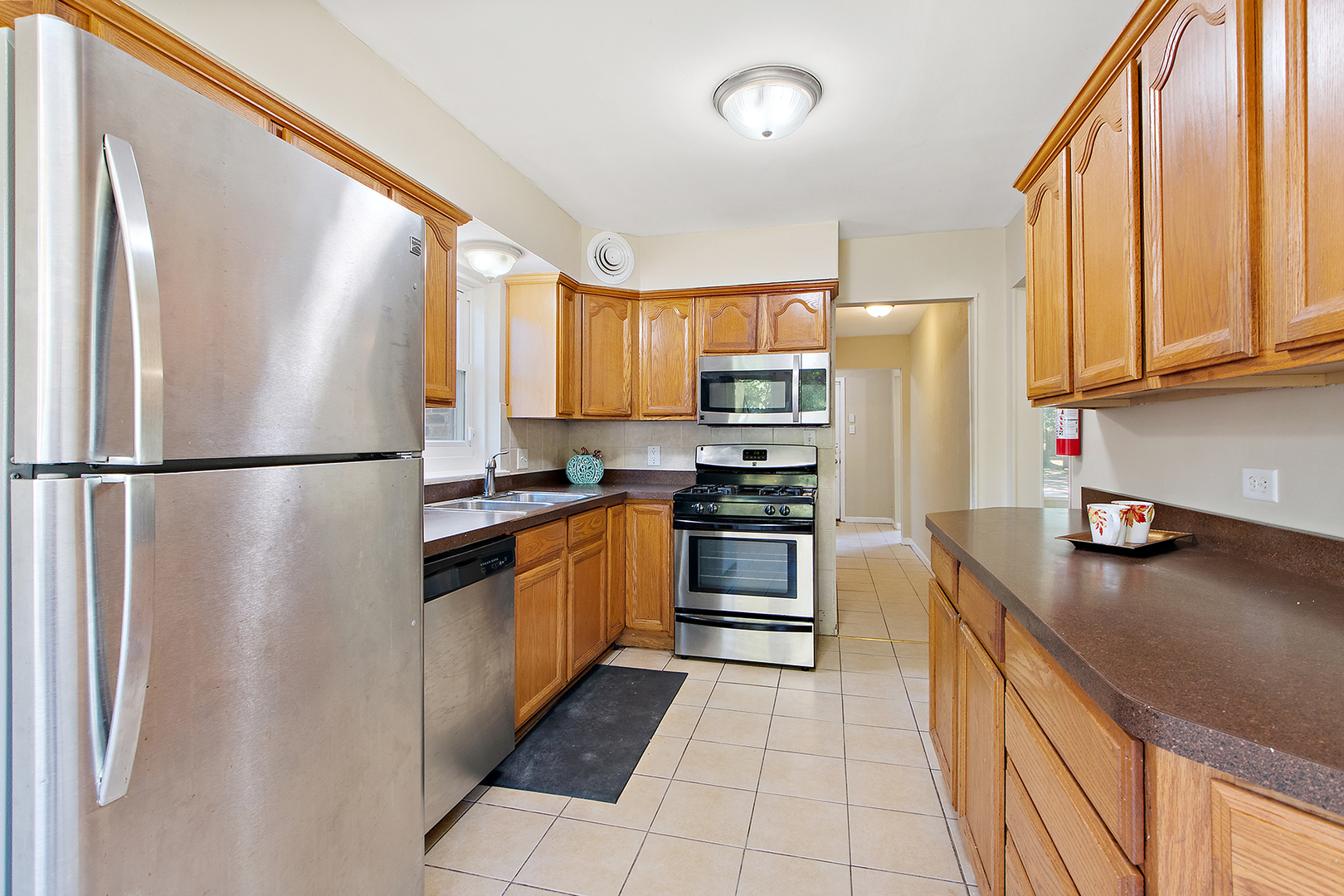 1718 West 187th Street Homewood, IL 60430 - Photo 9 of 28 a kitchen with stainless steel appliances granite countertop a refrigerator sink and cabinets
