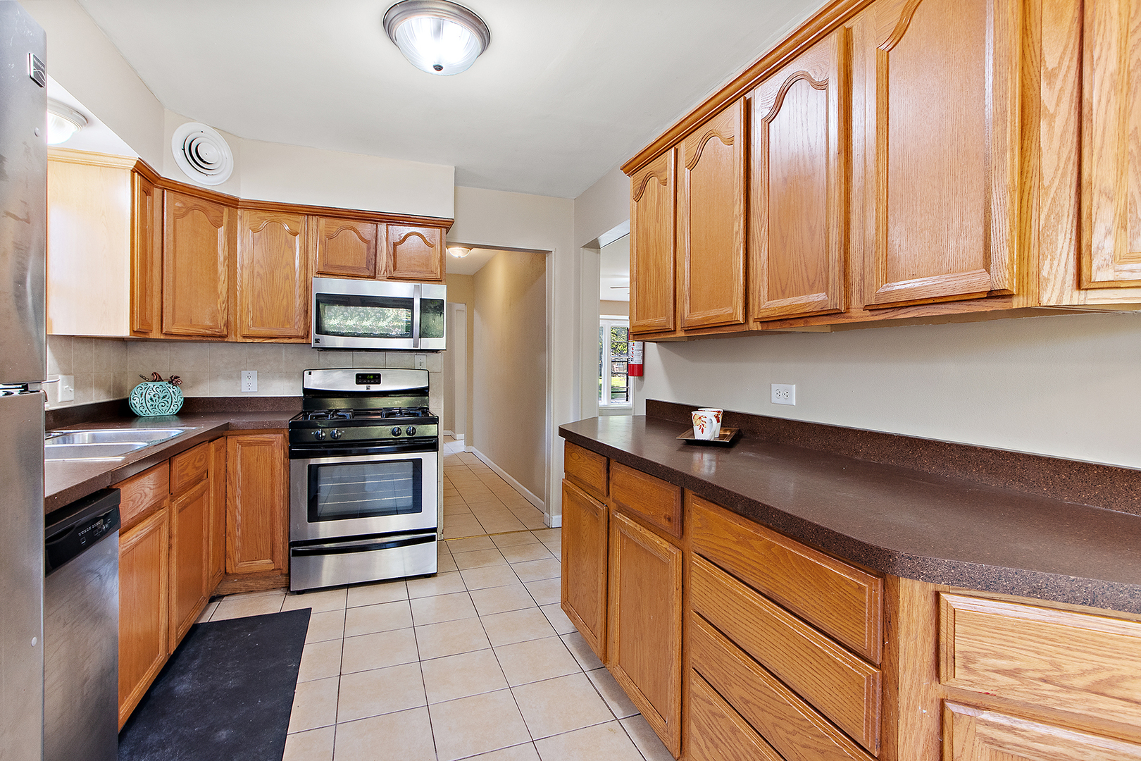 1718 West 187th Street Homewood, IL 60430 - Photo 10 of 28 a kitchen with stainless steel appliances a stove sink and cabinets